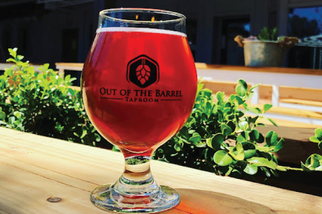 Out of the Barrel logo across a glass of beer